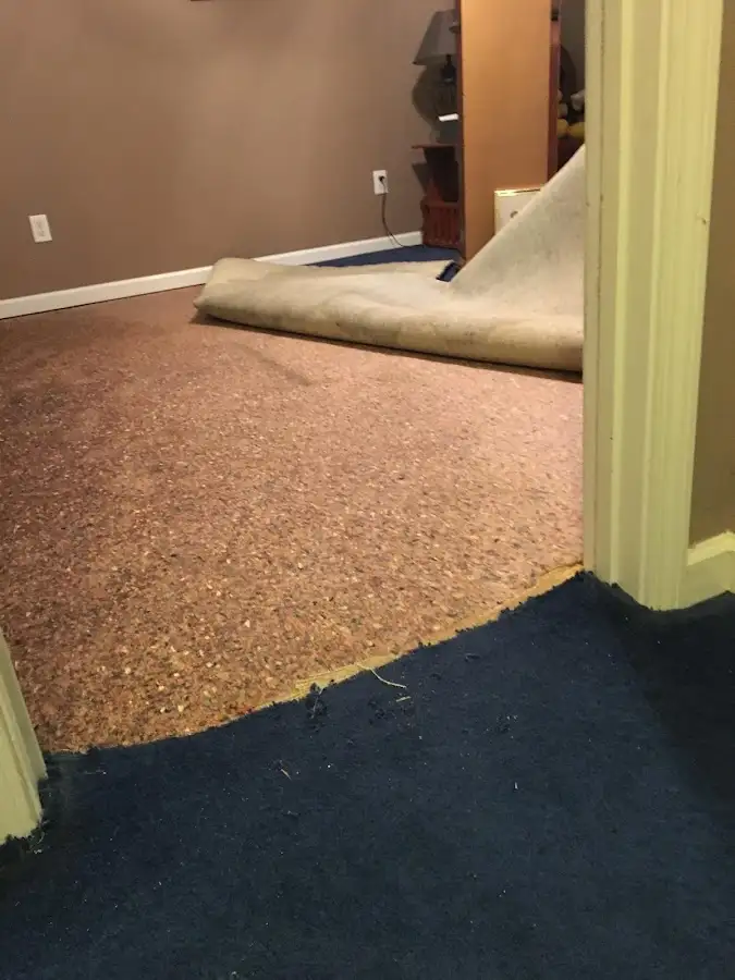 Carpet pad removal revealing water damage during Drying & Dehumidification in Jasper